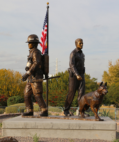 close up of Tempe Public Safety Memorial with American flag in the background