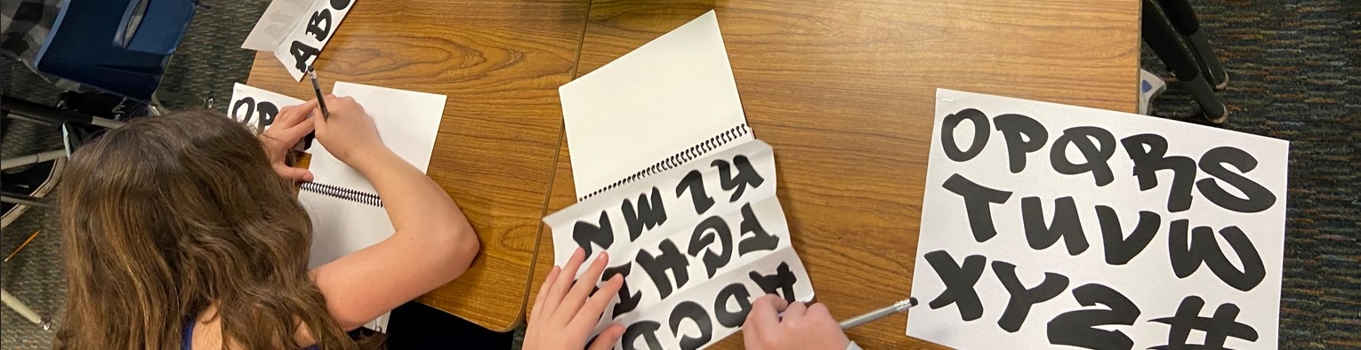 Children studying street art fonts