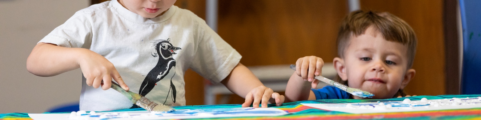 Two young boys painting