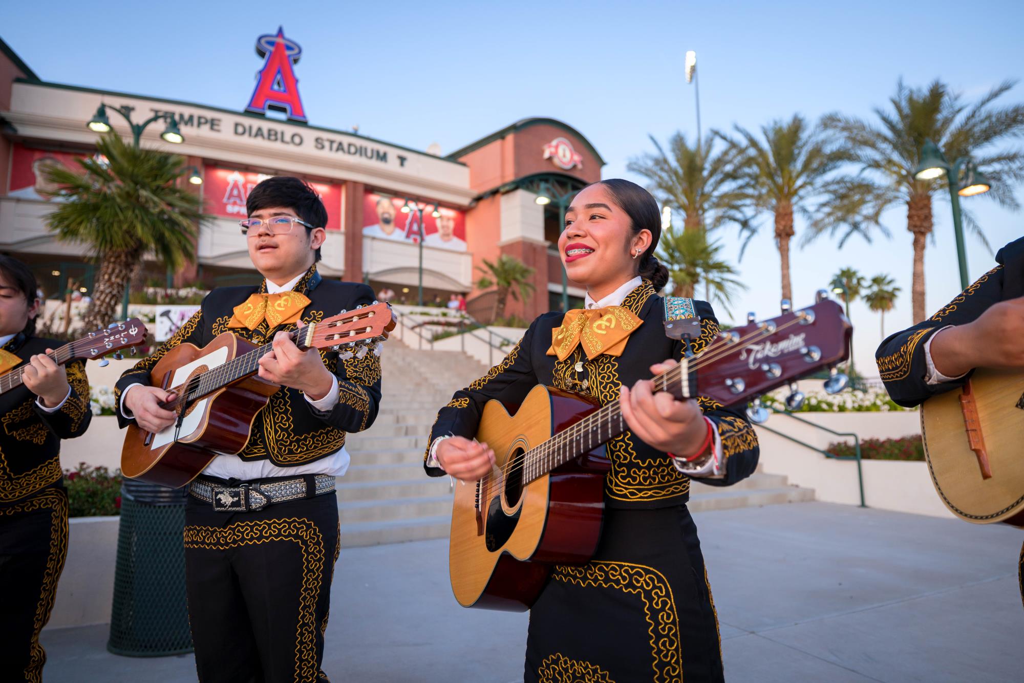 Teens performing with a mariachi band