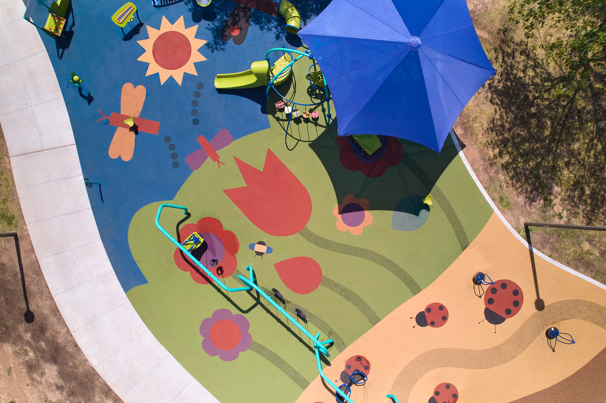 Aerial image of a playground with colorful design on the ground.