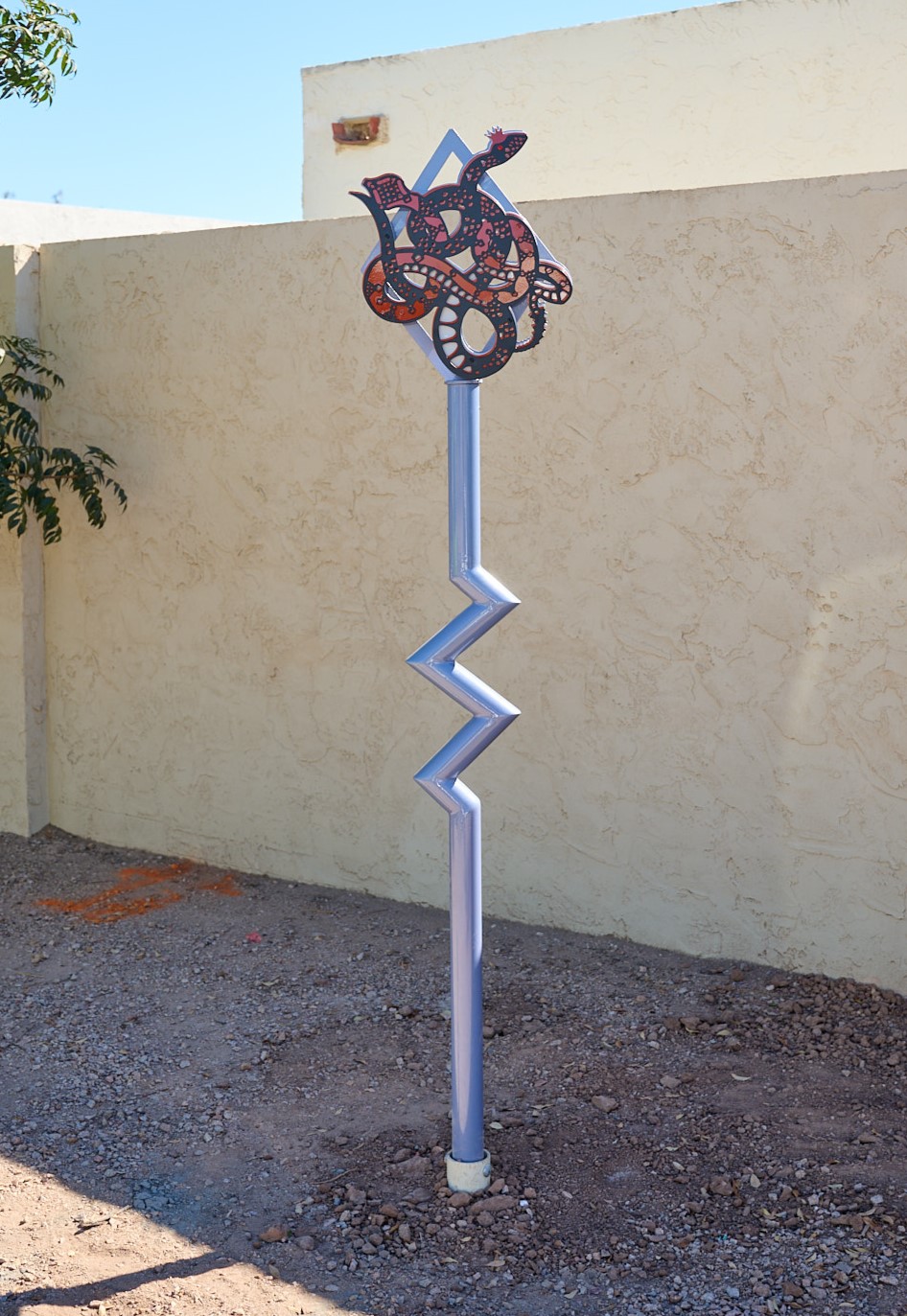 Steel posts sculptures depicting flora and fauna at the top.