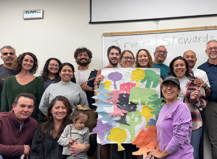 group of people holding tree artwork